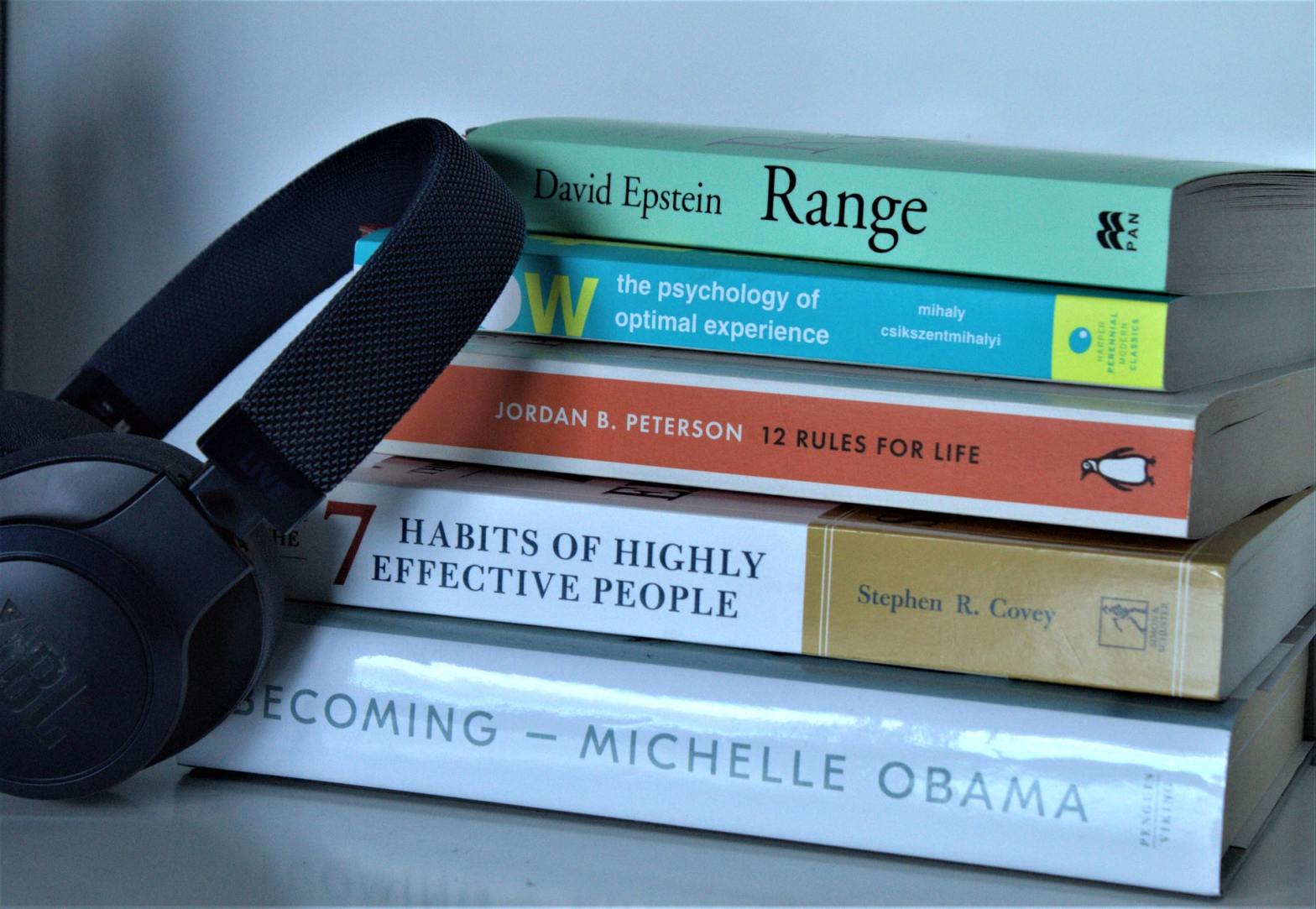 Pile of books and a headphone